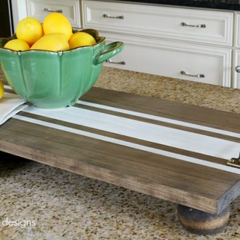 Make your own DIY Striped Serving Tray with only a handful of items from the hardware store. This tray is gorgeous for kitchen decor and makes the perfect holiday gift idea, too! #DIYHomeDecor #DIYProject #KitchenDecor #HomeDecorIdeas #GiftIdeas #HolidayGiftIdeas #FarmhouseDecor #HolidayFarmhouseDecor #FarmhouseFaves
