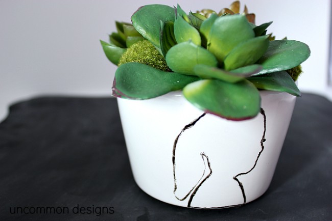 Personalize a planter or pot with a painted silhouette!  An easy project that looks like a million bucks and makes a perfect gift!  #MothersDay  #DecoArt  via www.uncommondesignsonline.com