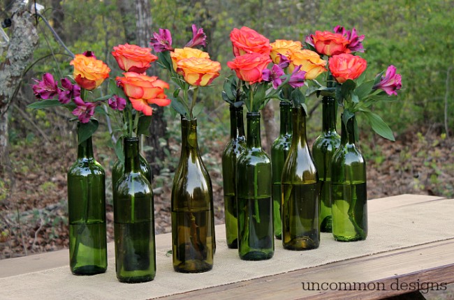 Make an Easy and Elegant Floral Centerpiece out of Wine Bottles! Perfect for weddings, bridal showers, and parties! www.uncommondesignsonline.com #WeddingCenterpiece #OutdoorEntertaining