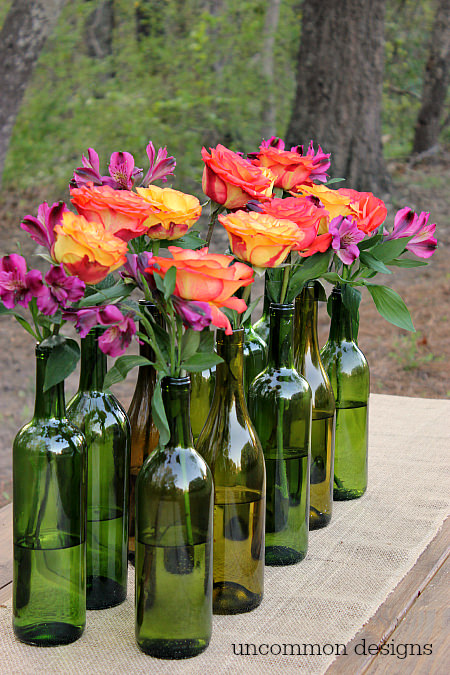 Make an Easy and Elegant Floral Centerpiece out of Wine Bottles! Perfect for weddings, bridal showers, and parties! www.uncommondesignsonline.com #WeddingCenterpiece #OutdoorEntertaining