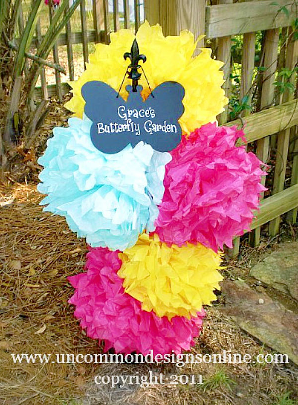 Paper Tissue pom poms as an entrance to a birthday party via Uncommon Designs.