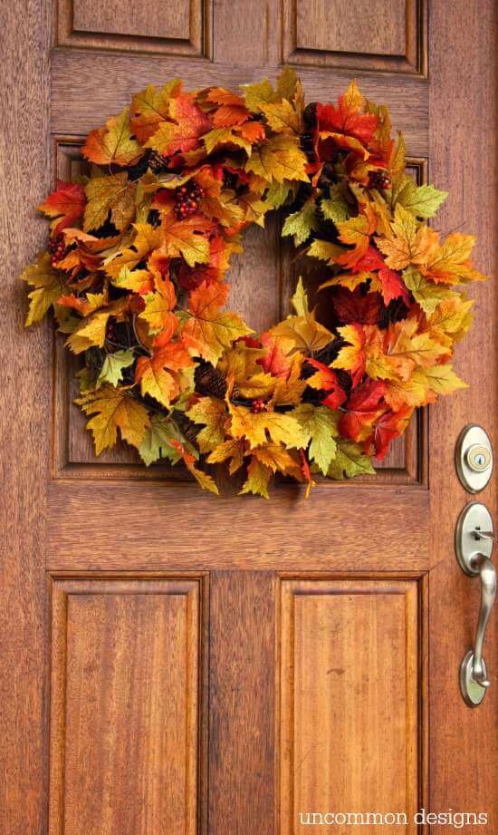 Beautiful DIY Thanksgiving wreaths adorned with autumn leaves, pumpkins, and berries.