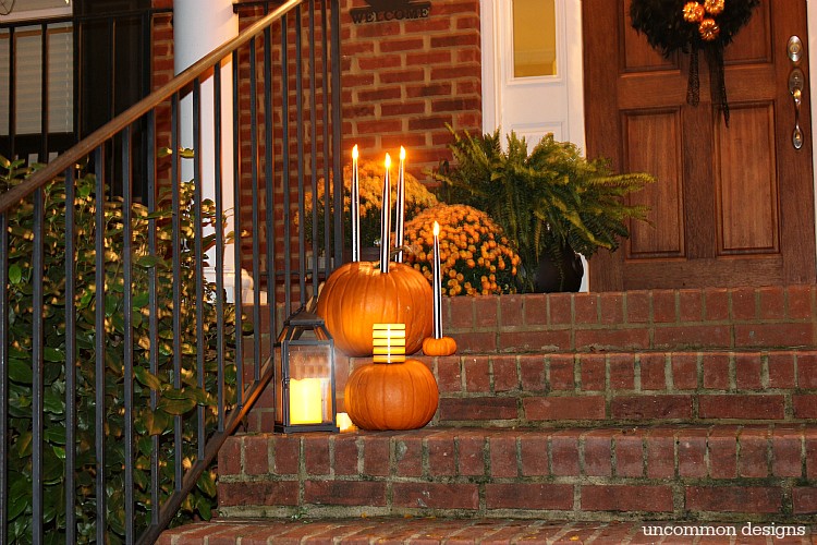 Make pumpkins into candle holders for your battery operated taper and pillar candles. So easy, but such a creative Halloween porch idea! | Uncommon Designs 