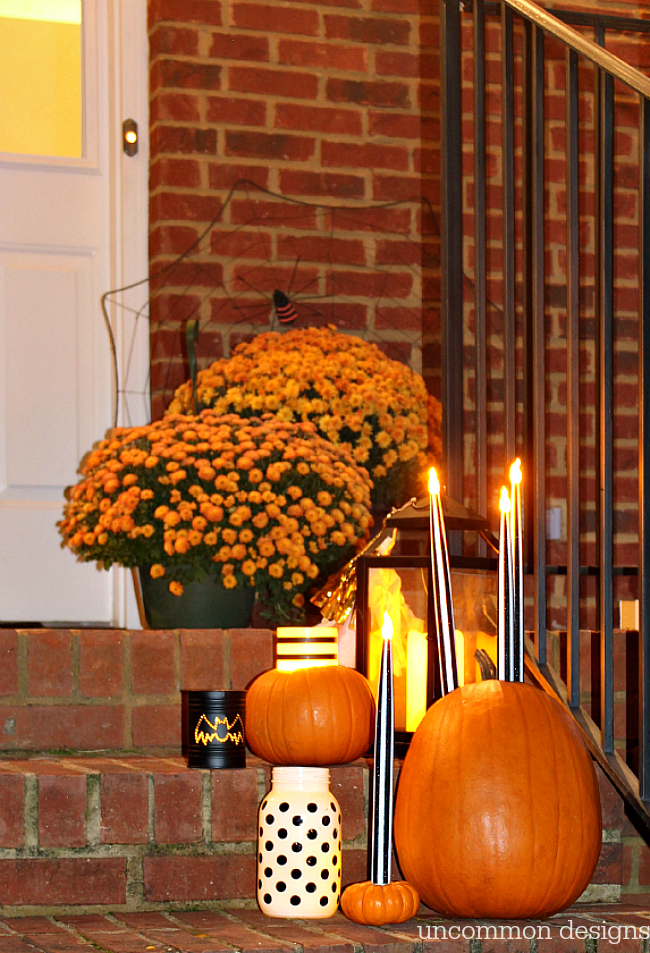 Make pumpkins into candle holders for your battery operated taper and pillar candles. So easy, but such a creative Halloween porch idea! | Uncommon Designs 