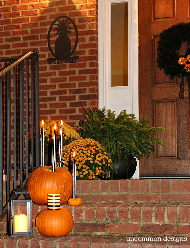 Make pumpkins into candle holders for your battery operated taper and pillar candles. So easy, but such a creative Halloween porch idea! | Uncommon Designs 