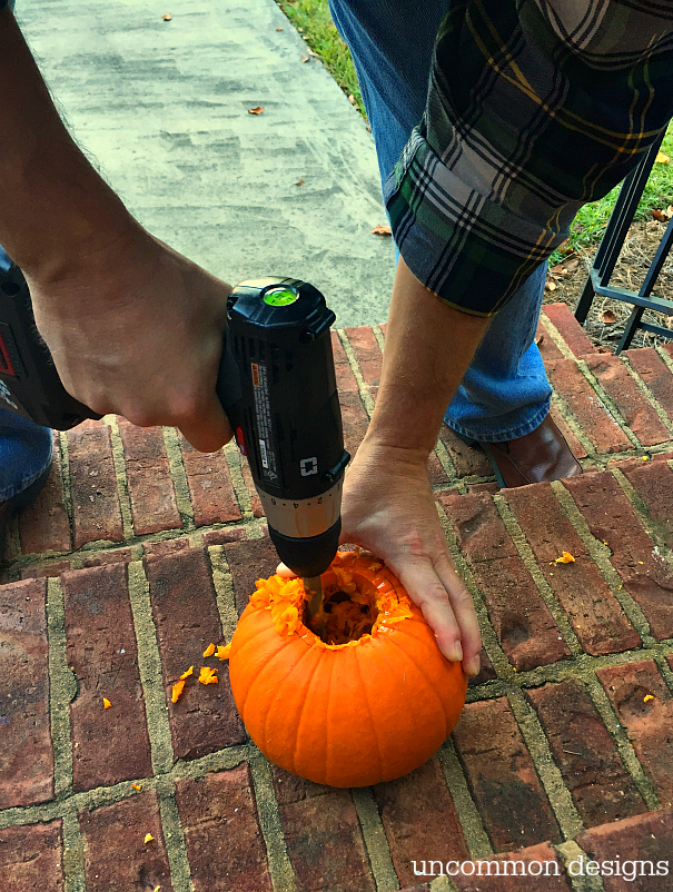 Make pumpkins into candle holders for your battery operated taper and pillar candles. So easy, but such a creative Halloween porch idea! | Uncommon Designs 