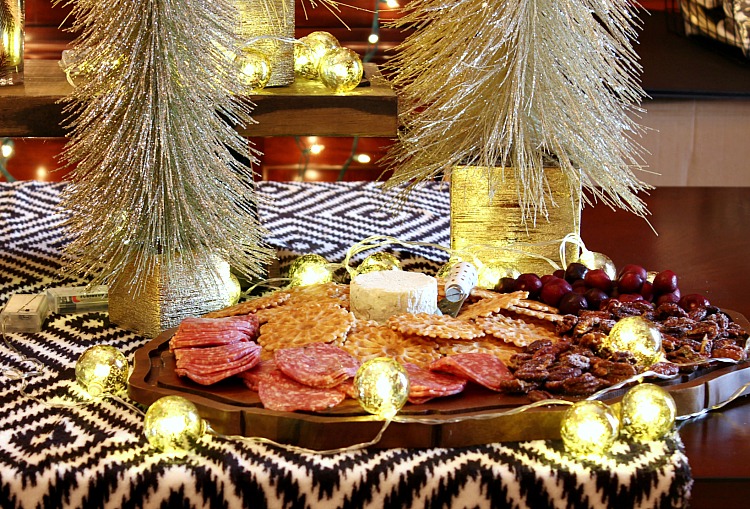 How to wow your guests with an upscale holiday appetizer board. Boursin gourmet cheese, crackers, nuts, salami and a sweet fruit make it a simple appetizer. 