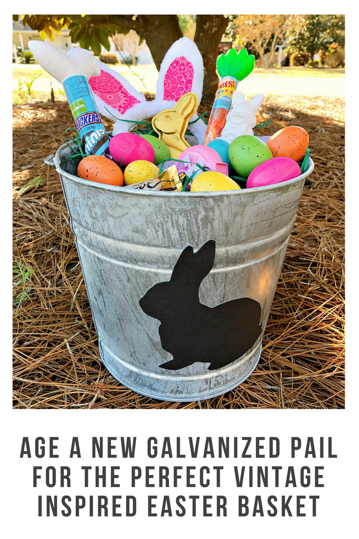 How to age a new galvanized pail to make the perfect vintage inspired Easter basket. Just look at that adorable bunny silhouette and anyone can do this! #ad #SweeterEaster