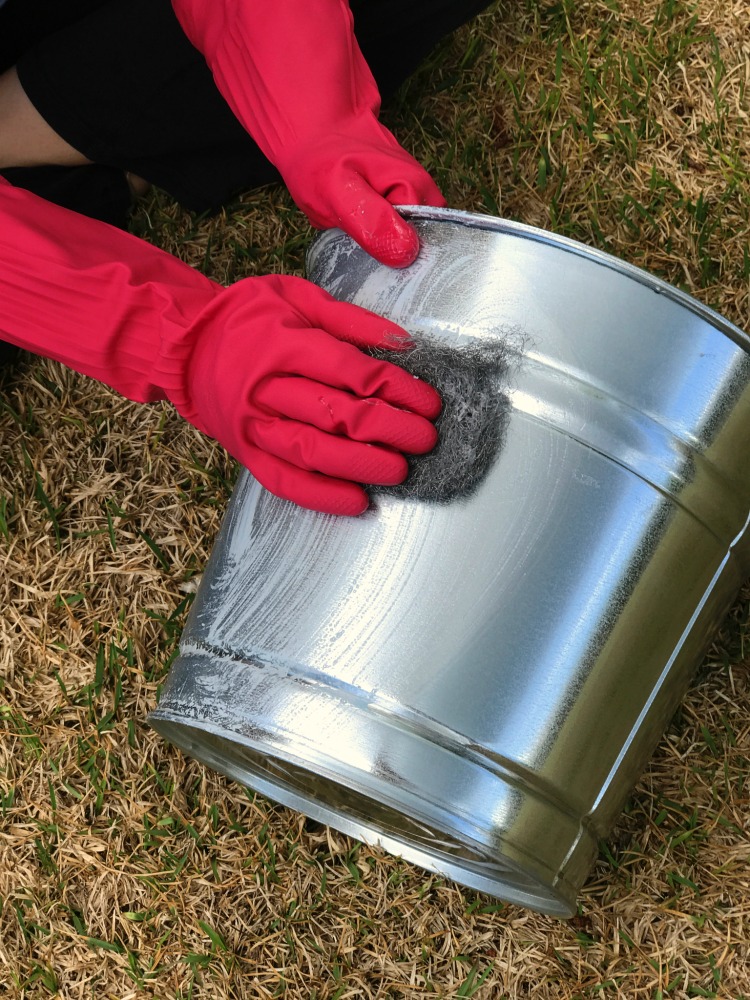 Aging a new galvanized pail to have a vintage aged finish. From shiny to aged in just a few moments.