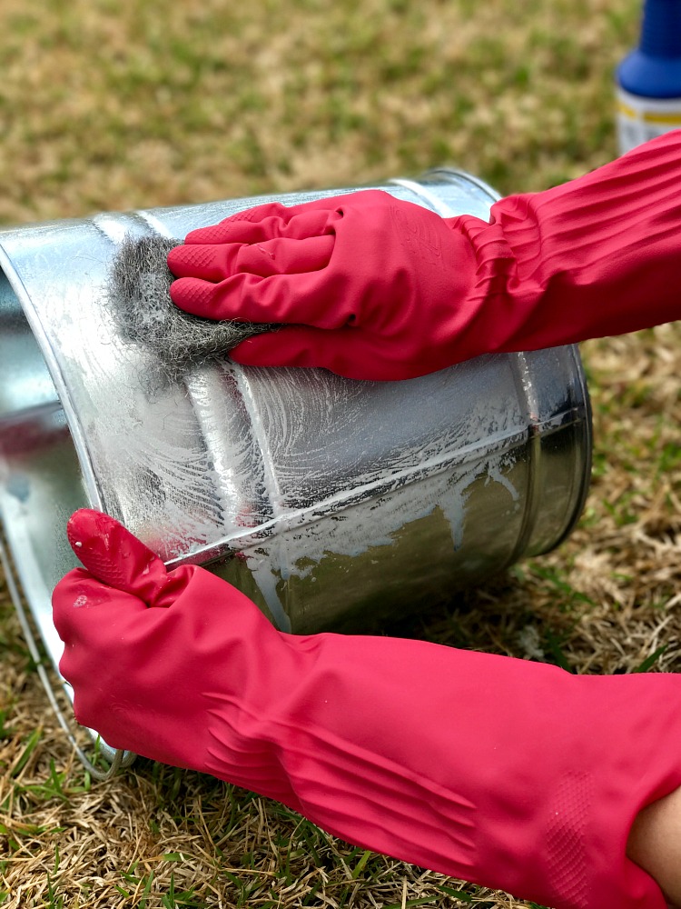 Aging a new galvanized pail to have a vintage aged finish. From shiny to aged in just a few moments.